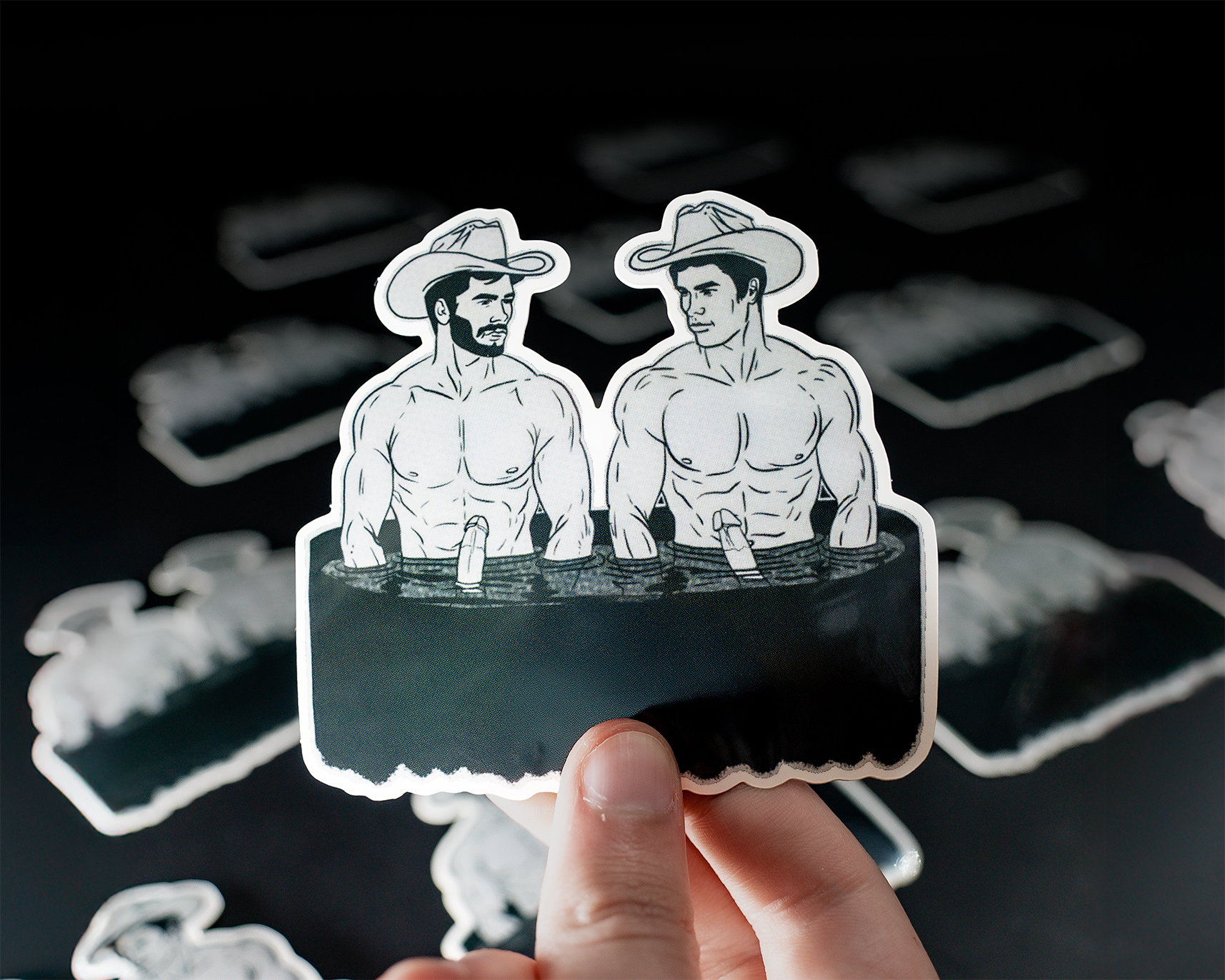 Two naked cowboys sitting in a tub
