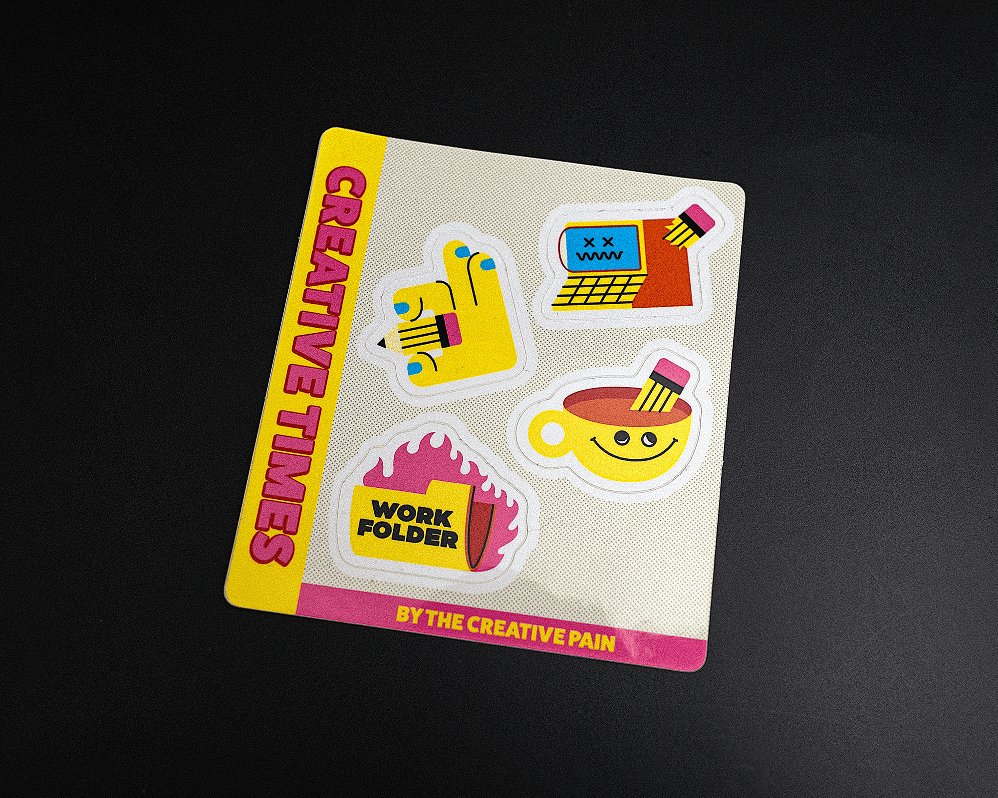 Sticker sheet titled "Creative Times" with colorful designs: a typewriter, paintbrush, work folder, and smiling cup on a black background.